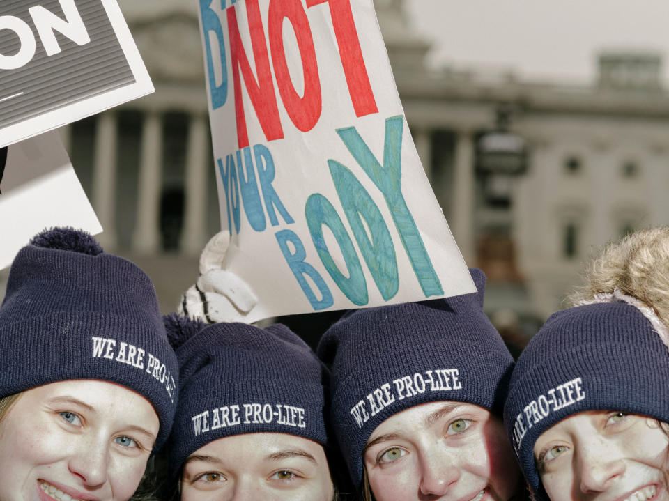 Attendees of the March for Life, held the day before the anniversary of the Supreme Court ruling of Roe v. Wade, stand in front of the Supreme Court building in Washington, on Jan. 21.<span class="copyright">M. Levy for TIME</span>