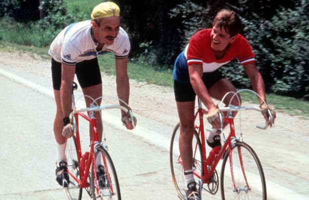 <p>Kevin Costner and David Grant biking in a scene from the 1985 film <em>American Flyers</em>. </p>