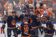 Edmonton Oilers' Evander Kane (91), Connor McDavid (97), Evan Bouchard (75), Zach Hyman (18) and Duncan Keith (2) celebrate McDavid's goal against the Colorado Avalanche during the first period of Game 3 of the NHL hockey Stanley Cup playoffs Western Conference finals, Saturday, June 4, 2022, in Edmonton, Alberta. (Amber Bracken/The Canadian Press via AP)
