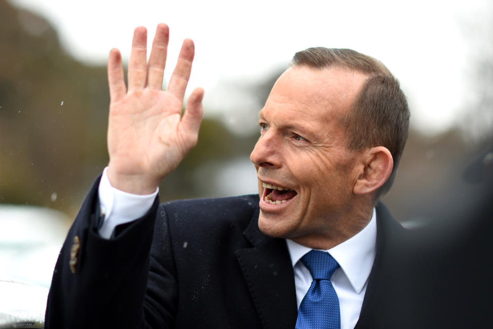 Australian Prime Minister Tony Abbott waves as he leaves after visiting a Green Army volunteering project in Queanbeyan, near Canberra, Wednesday, Aug. 12, 2015. (AAP Image/Lukas Coch) NO ARCHIVING