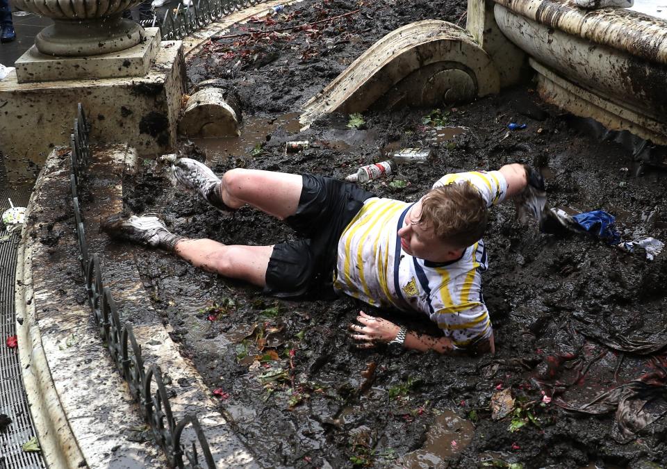 Peaked too soon? One fan was pictured rolling around in the mud. (PA)