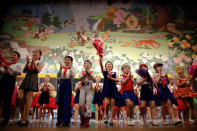 Children wave to spectators as the curtain is brought down at the end of a performance at the Mangyongdae Children's Palace in Pyongyang, North Korea May 5, 2016. REUTERS/Damir Sagolj