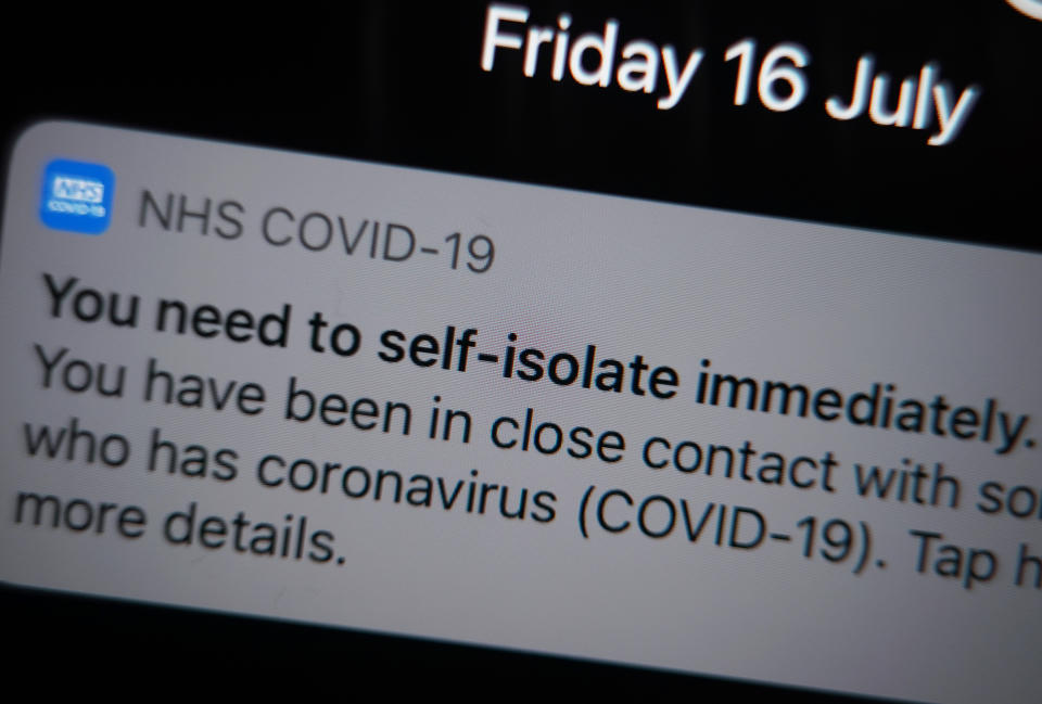 A notification issued by the NHS coronavirus contact tracing app - informing a person of the need to self-isolate immediately, due to having been in close contact with someone who has coronavirus - is displayed on a mobile phone in London, during the easing of lockdown restrictions in England. Picture date: Friday July 16, 2021.