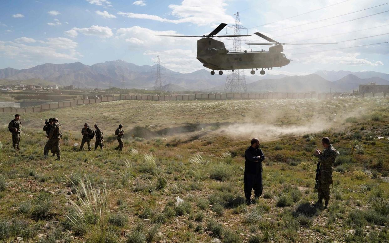  In this file photo taken on June 6, 2019, a US military Chinook helicopter lands on a field outside the governor's palace during a visit by the commander of US and NATO forces in Afghanistan, General Scott Miller, and Asadullah Khalid, acting minister of defense of Afghanistan, in Maidan Shar, capital of Wardak province.