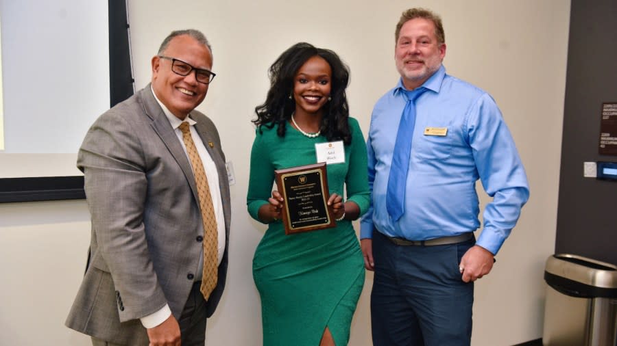 Kimaya Bak (center) accepts the Penny Bundy Leadership Award for 2022-23.