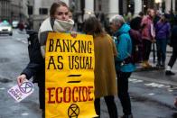 An Extinction Rebellion volunteer protests to highlight the role of banks in financing fossil fuel projects undermining the 2015 Paris Agreement to curb climate change, in London