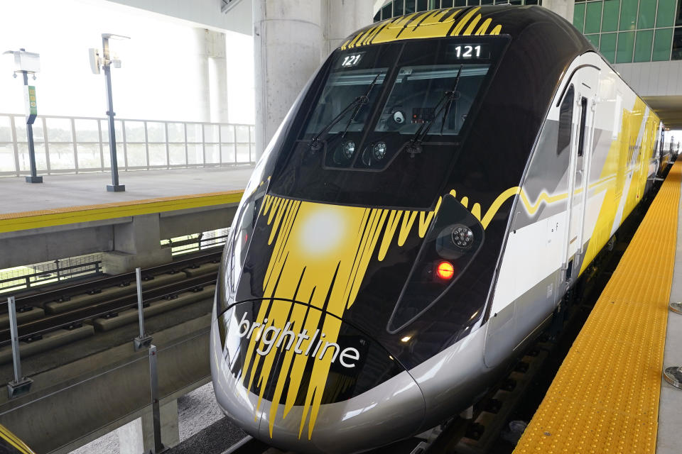 A Brightline train is parked at the Orlando station to celebrate the completion of the construction of the Brightline high speed rail on Wednesday, June 21, 2023, in Orlando, Fla. The rail system now connects Miami to Orlando. (AP Photo/John Raoux)