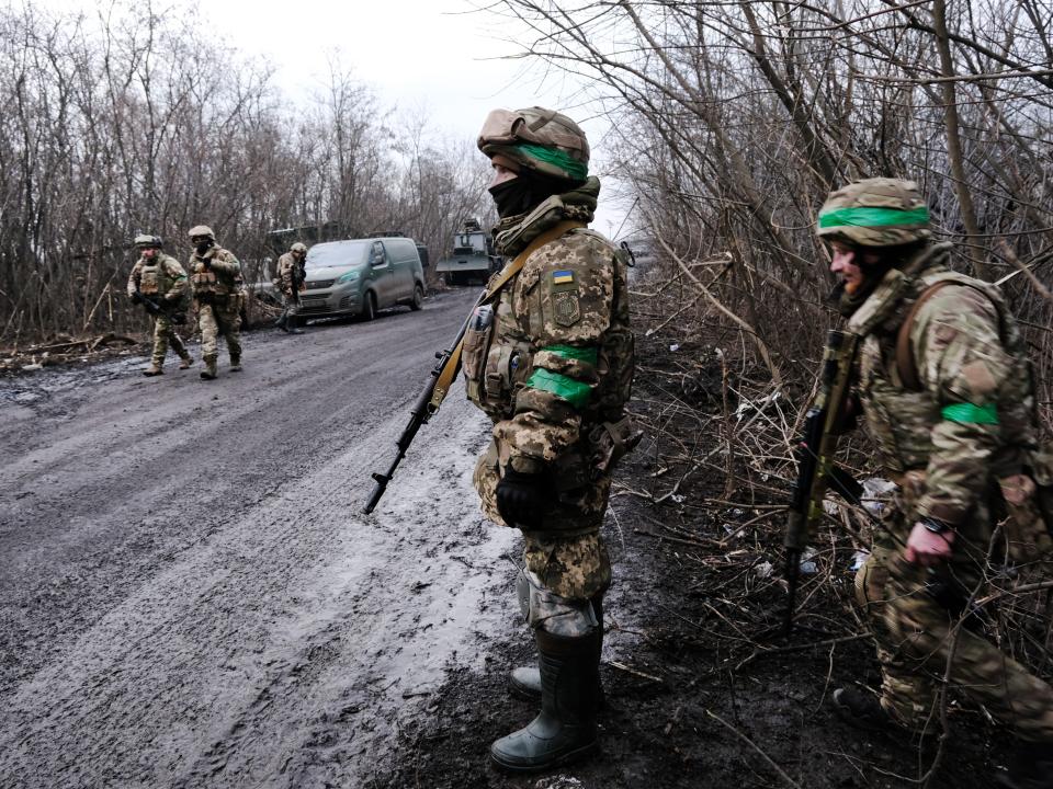 Ukrainian soldiers shelter in the woods along a road outside of the strategic city of Bakhmut on January 18, 2023 in Bakhmut, Ukraine.