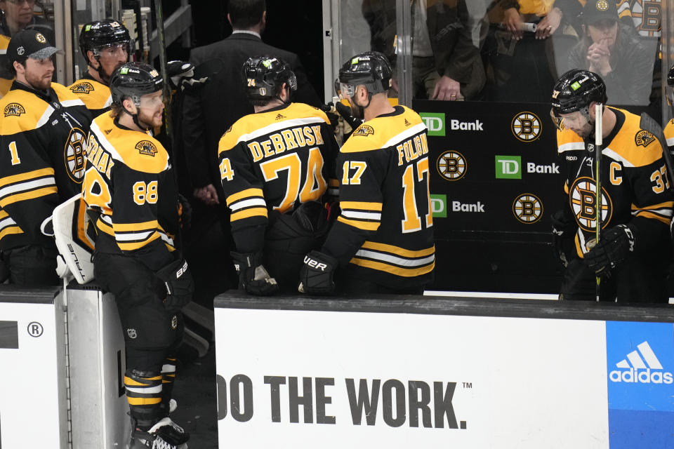 The Boston Bruins head to the locker room after a 4-3 overtime loss to the Florida Panthers in Game 5 of an NHL hockey Stanley Cup first-round playoff series Wednesday, April 26, 2023, in Boston. (AP Photo/Charles Krupa)