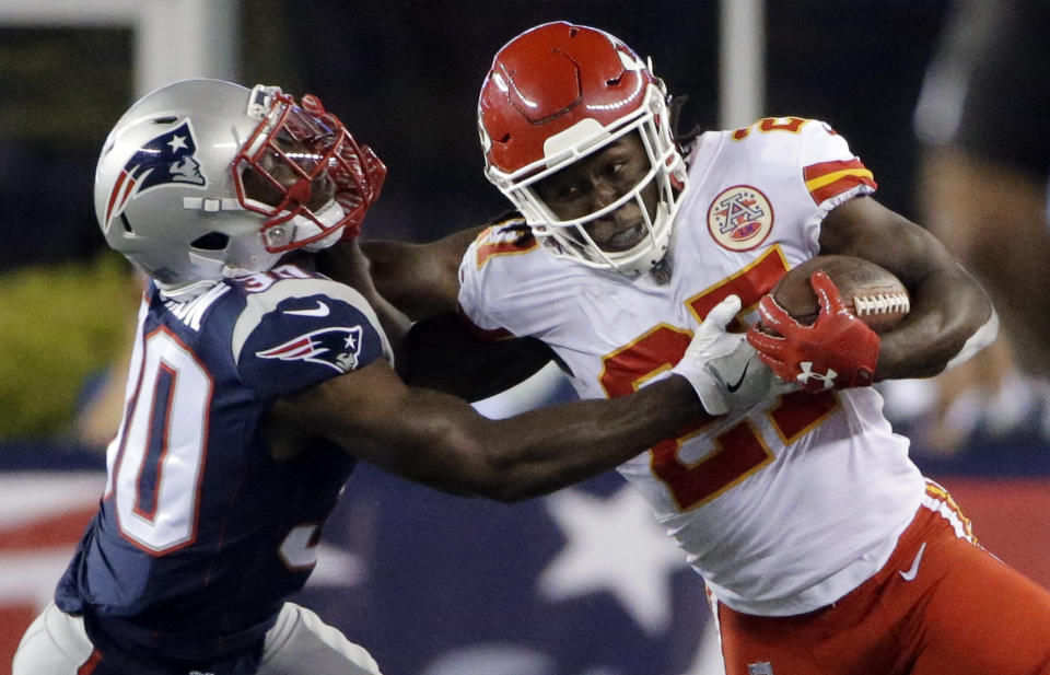 <p>Kansas City Chiefs running back Kareem Hunt (27) gives a stiff arm to New England Patriots safety Duron Harmon (30) during the first half of an NFL football game, Thursday, Sept. 7, 2017, in Foxborough, Mass. (AP Photo/Steven Senne) </p>