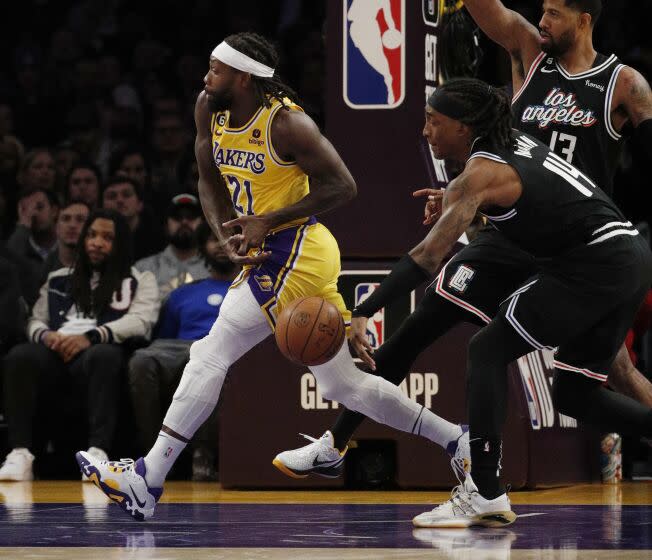 Clippers guard Terance Mann (14) strips the ball from Los Angeles Lakers guard Patrick Beverley