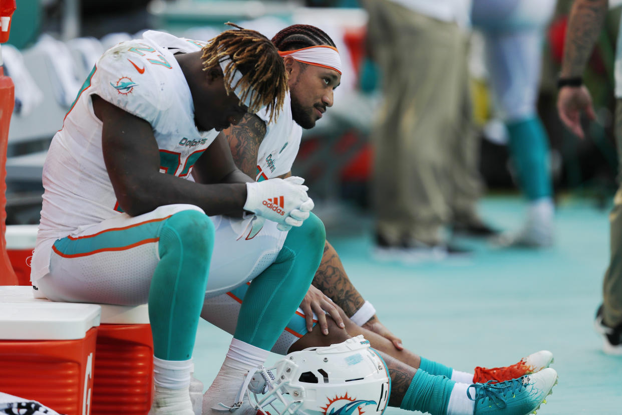 Miami Dolphins running back Kalen Ballage (27) sits on the sidelines late in the team's 59-10 loss to Baltimore. (AP)