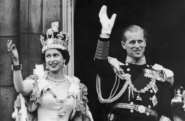 PHOTO: Queen Elizabeth II and the Duke of Edinburgh wave at the crowds from the balcony at Buckingham Palace after Elizabeth's coronation, June 2, 1953, in London. (Keystone/Getty Images)