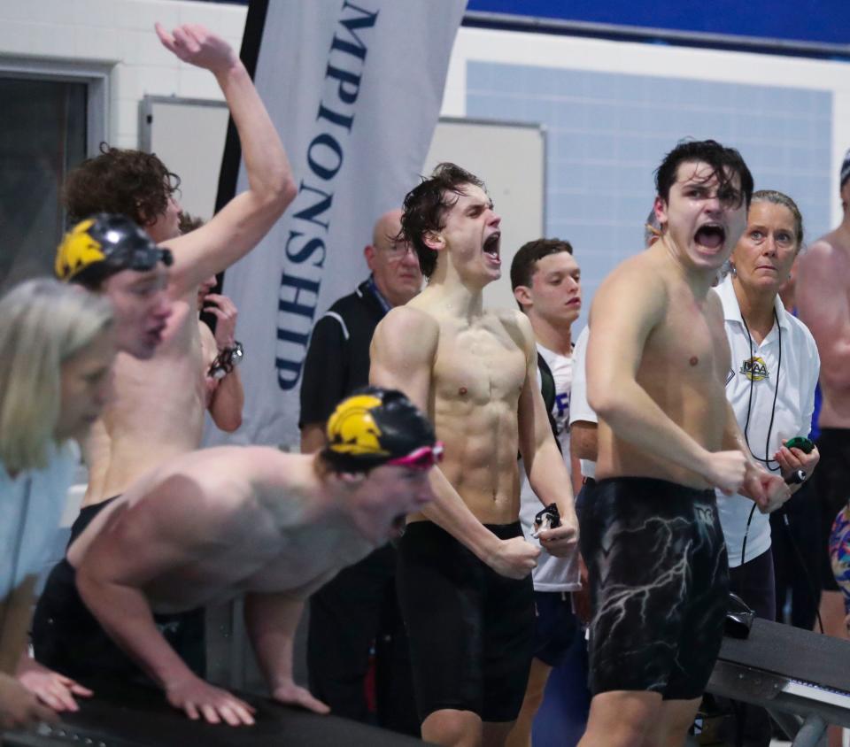 Salesianum's John Canfield, Teddy Tsakumis and Bryce Patterson cheer as they win the 400 yard freestyle relay to cap the action in the DIAA boys swimming state championships at the Rawstrom Natatorium at the University of Delaware, Saturday, Feb. 25, 2023.