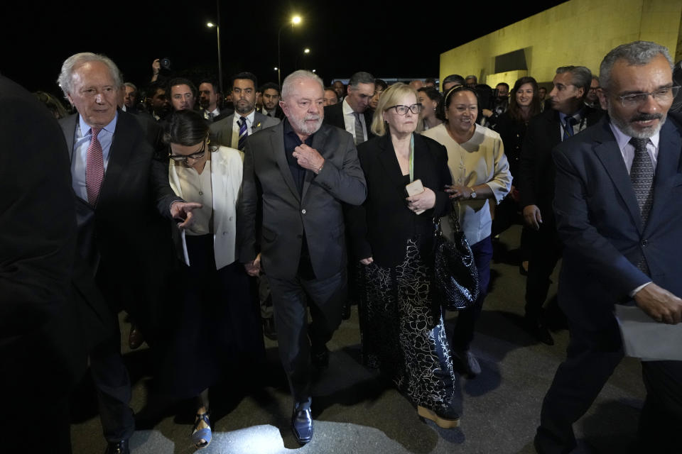 Brazil's President Luiz Inacio Lula da Silva, center, President of the Supreme Court Rosa Weber, center right, are accompanied by governors and ministers for an inspection visit and support for the Supreme Court headquarters, day after Congress was stormed by supporters of former Brazilian President Jair Bolsonaro in Brasilia, Brazil, Monday, Jan. 9, 2023. The protesters also stormed the presidencial office and the Supreme Court. (AP Photo/Eraldo Peres)