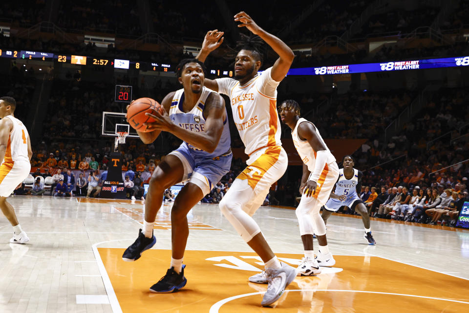 McNeese State forward Malachi Rhodes (23) works for a shot against Tennessee forward Jonas Aidoo (0) during the first half of an NCAA college basketball game Wednesday, Nov. 30, 2022, in Knoxville, Tenn. (AP Photo/Wade Payne)