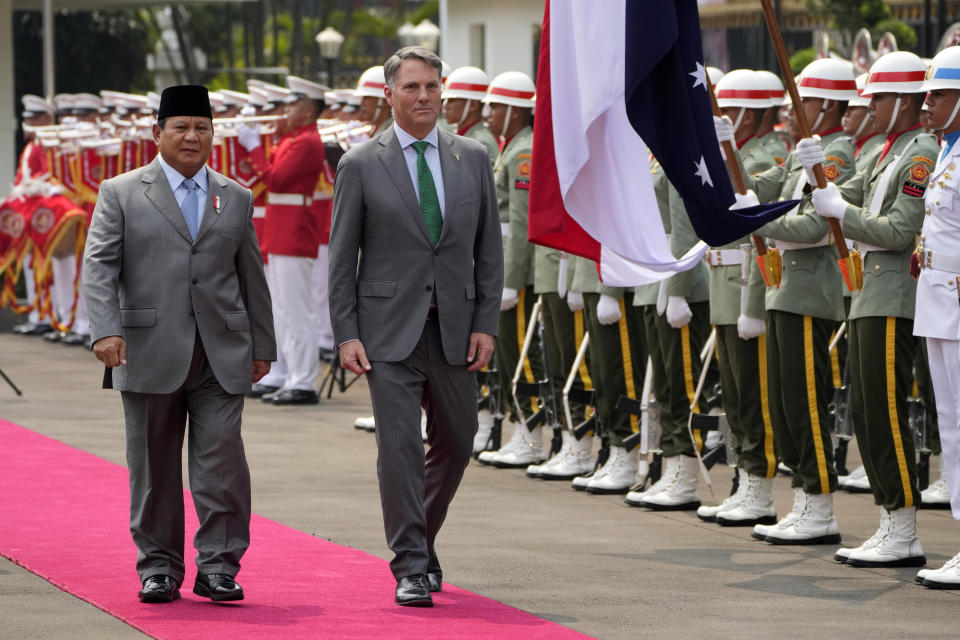 Australia's Deputy Prime Minister and Defense Minister Richard Marles, center, inspects honor guards with Indonesian Defense Minister Prabowo Subianto during their meeting in Jakarta, Indonesia, Monday, June 5, 2023. (AP Photo/Dita Alangkara)