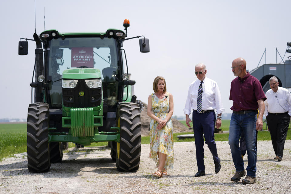 President Joe Biden walks with O'Connor Farms owners Jeff O'Connor and Gina O'Connor, left, at the farm Wednesday, May 11, 2022, in Kankakee, Ill. Agriculture Secretary Tom Vilsack walks at right. Biden visited the farm to discuss food supply and prices as a result of Putin's invasion of Ukraine. (AP Photo/Andrew Harnik)