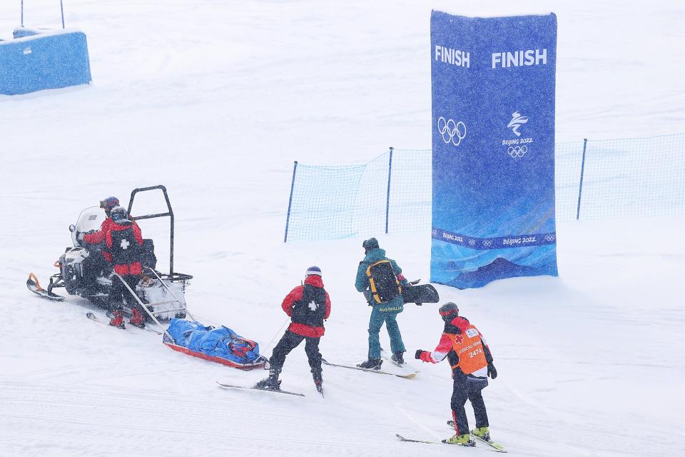 Belle Brockhoff of Team Australia is stretched off the mountain after crashing during the Snowboard Mixed Team Cross Quarterfinals on Day 8 of the Beijing 2022 Winter Olympics (Getty Images)