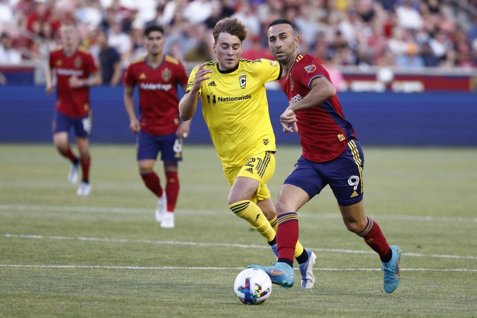 Jun 25, 2022; Sandy, Utah, USA; Real Salt Lake forward Justin Meram (9) gets off a pass against Columbus Crew midfielder Aidan Morris (21) in the first half at Rio Tinto Stadium. Mandatory Credit: Jeffrey Swinger-USA TODAY Sports