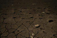 Cracked earth lines the banks of the Villa Victoria Dam, the main water supply for Mexico City residents, on the outskirts of Toluca, Mexico, Thursday, April 22, 2021. The mayor of Mexico City said Mexico's drought was the worst in 30 years. (AP Photo/Fernando Llano)