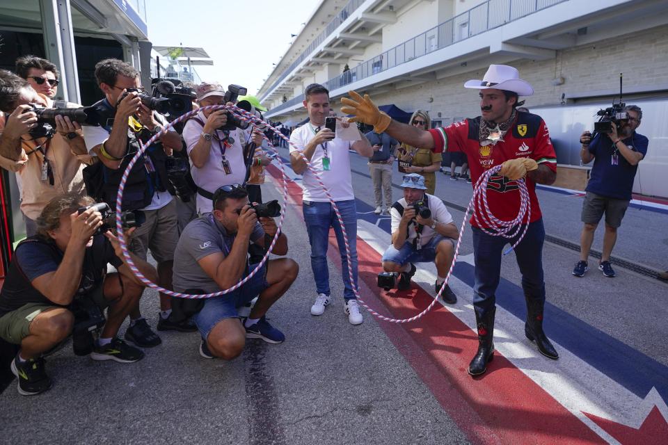 Ferrari driver Carlos Sainz of Spain tosses a rope in the paddock before the Formula One U.S. Grand Prix auto race at Circuit of the Americas, Thursday, Oct. 19, 2023, in Austin, Texas. (AP Photo/Darron Cummings)