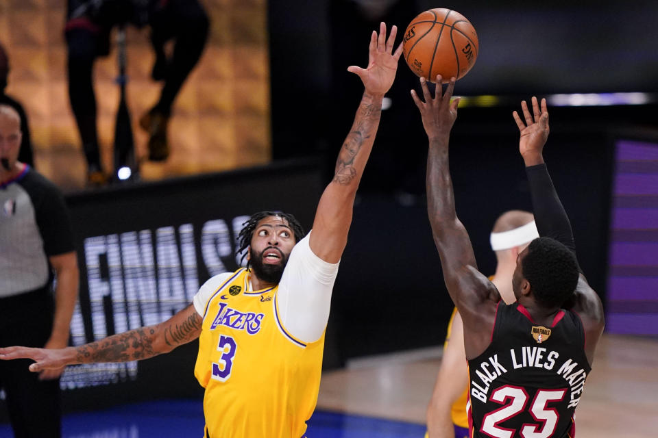 Miami Heat guard Kendrick Nunn, right, shoots over Los Angeles Lakers forward Anthony Davis during the first half in Game 4 of basketball's NBA Finals Tuesday, Oct. 6, 2020, in Lake Buena Vista, Fla. (AP Photo/Mark J. Terrill)