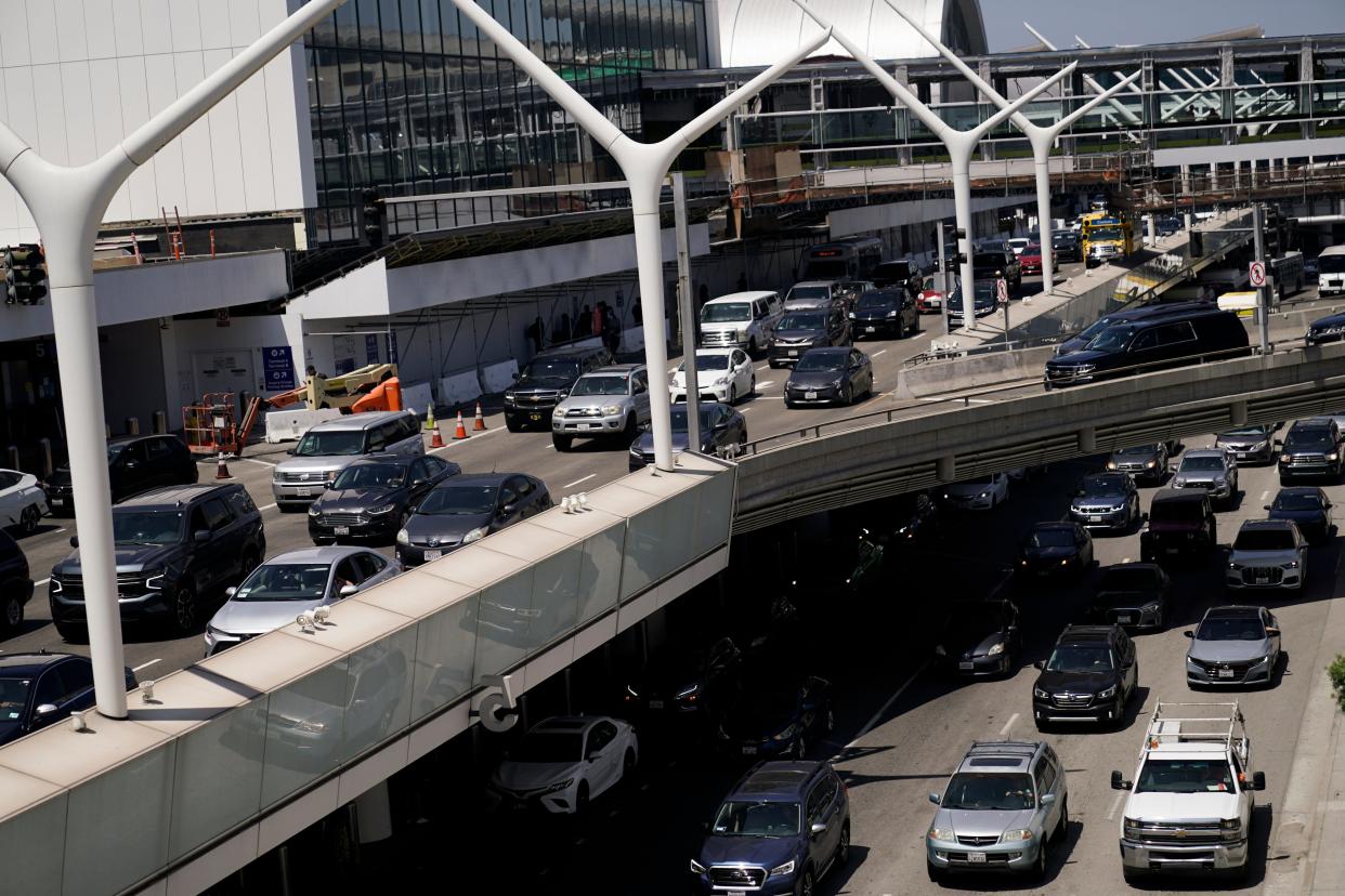 Traffic builds up outside terminals at the Los Angeles International Airport in Los Angeles, Friday, July 1, 2022. The July Fourth holiday weekend is off to a booming start with airport crowds crushing the numbers seen in 2019, before the pandemic. (AP Photo/Jae C. Hong)