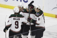 Arizona Coyotes center Nick Schmaltz celebrates with teammates after scoring a goal against the Minnesota Wild during the second period of an NHL hockey game, Sunday, Nov. 27, 2022, in St. Paul, Minn. (AP Photo/Stacy Bengs)