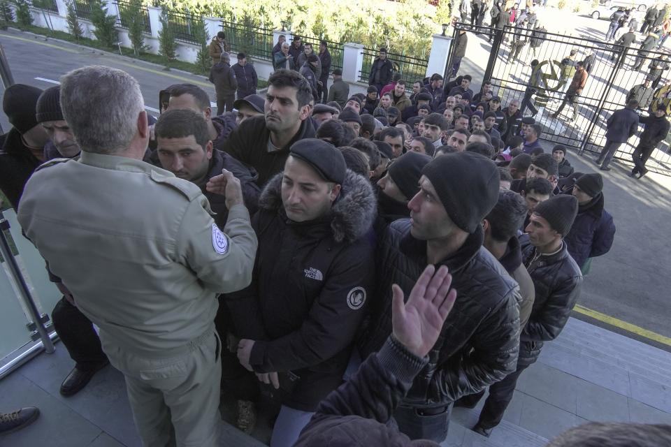 People line up to attend voting at a polling station during presidential election in Fuzuli in Karabakh region, Azerbaijan, Wednesday, Feb. 7, 2024. Azerbaijanis are voting Wednesday in an election almost certain to see incumbent President Ilhan Aliyev chosen to serve another seven-year term. (AP Photo/Sergei Grits)