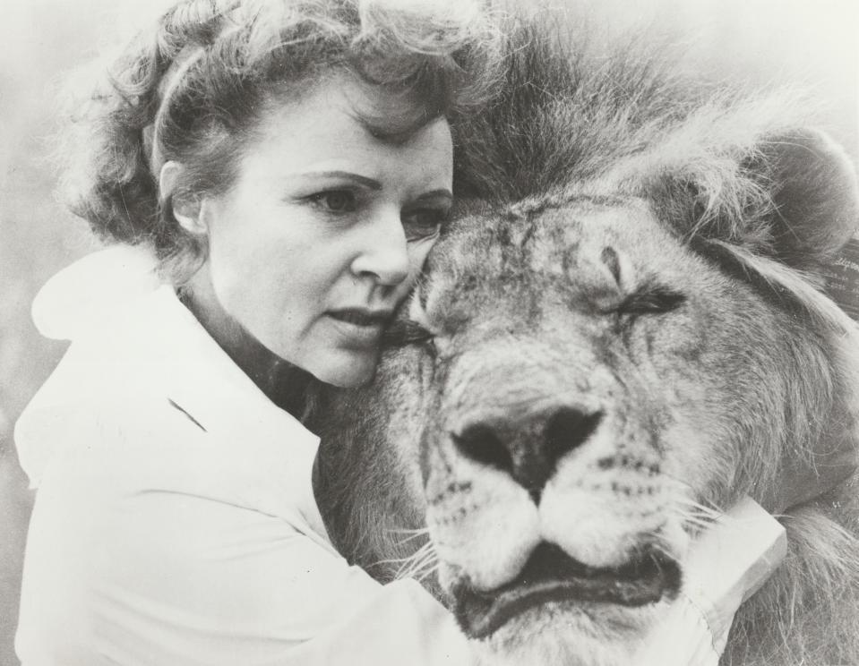 Betty White embracing a lion