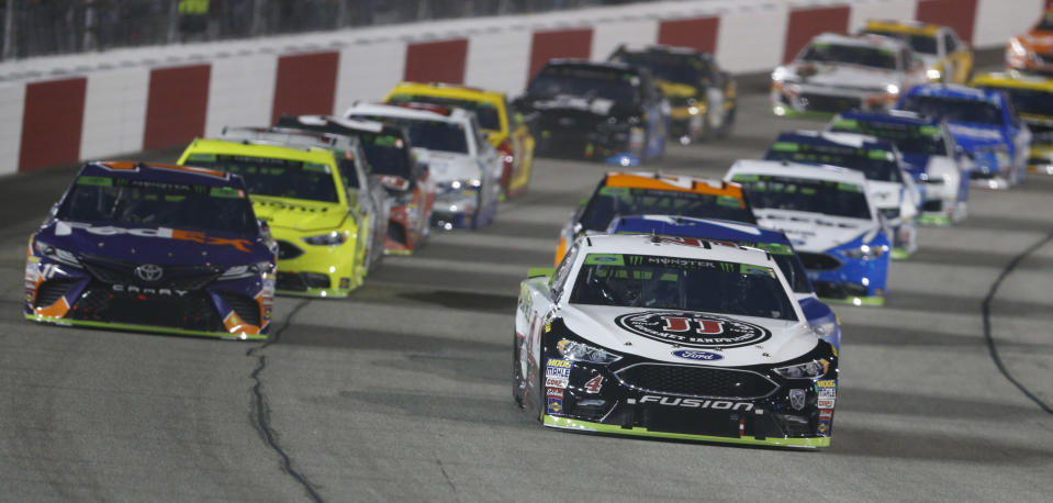 Kevin Harvick (4) leads the field at the start of the NASCAR Cup Series auto race at Richmond Raceway in Richmond, Va., Saturday, Sept. 22, 2018. (AP Photo/Steve Helber)