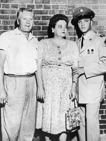 <p>Hulton Archive/Getty</p> Elvis Presley with his parents, Vernon and Gladys Presley circa 1958