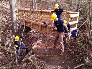 Volunteers helped build a retaining wall to give hikers a safer path when entering/exiting a newly built foot bridge in Front Royal, Virginia.