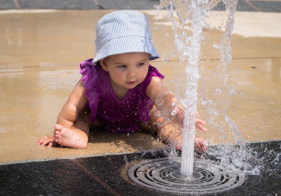 Ten-month-old Eleanor Trevino cools off while playing on the Liz Carpenter Splash Pad at Butler Park. A UT study confirmed that kids spend less time doing moderate to vigorous physical activity at 95 degrees than at 72 degrees.