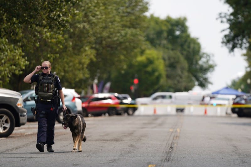 An officer and her canine patrol near the Senate office buildings on Capitol Hill after reports of a possible active shooter Wednesday. Photo by Bonnie Cash/UPI