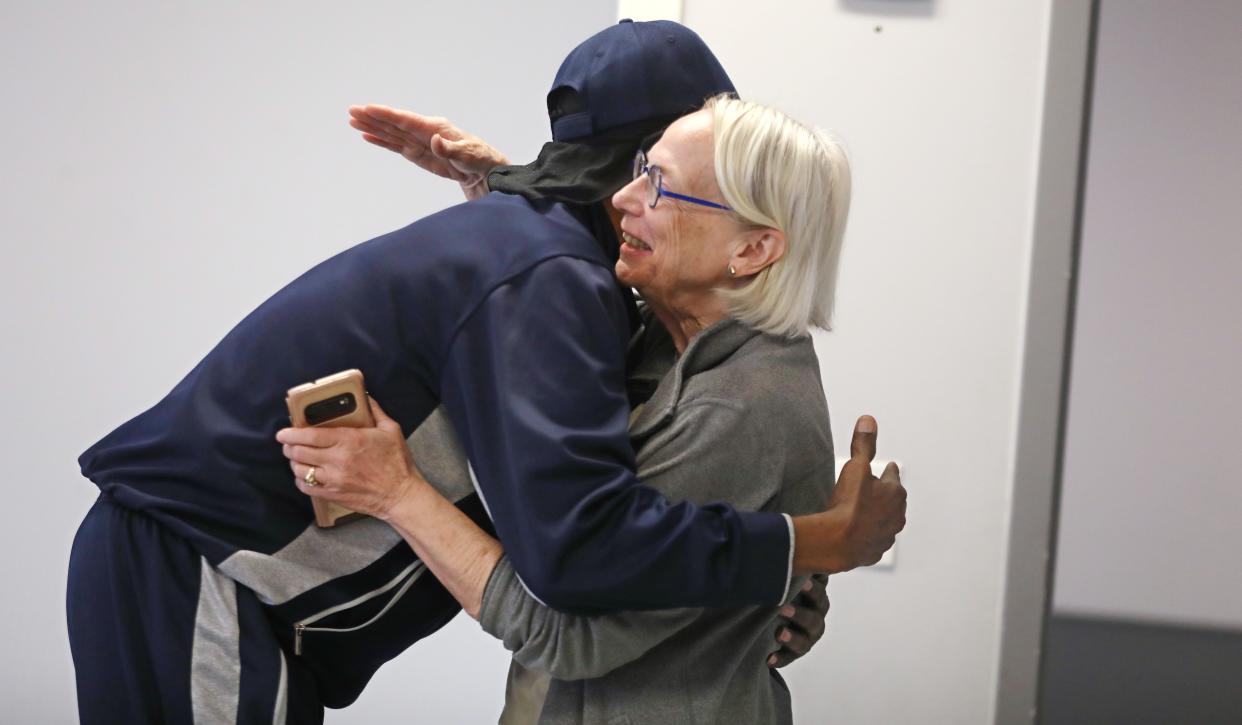 Hinge Neighbors President Suzanne Mayer is welcomed with a warm hug from David Everett as she stops in at a meeting held by the Fairy Grandparents group at the Lewis Street YMCA Neighborhood Center Friday, May 3, 2024 in Rochester.