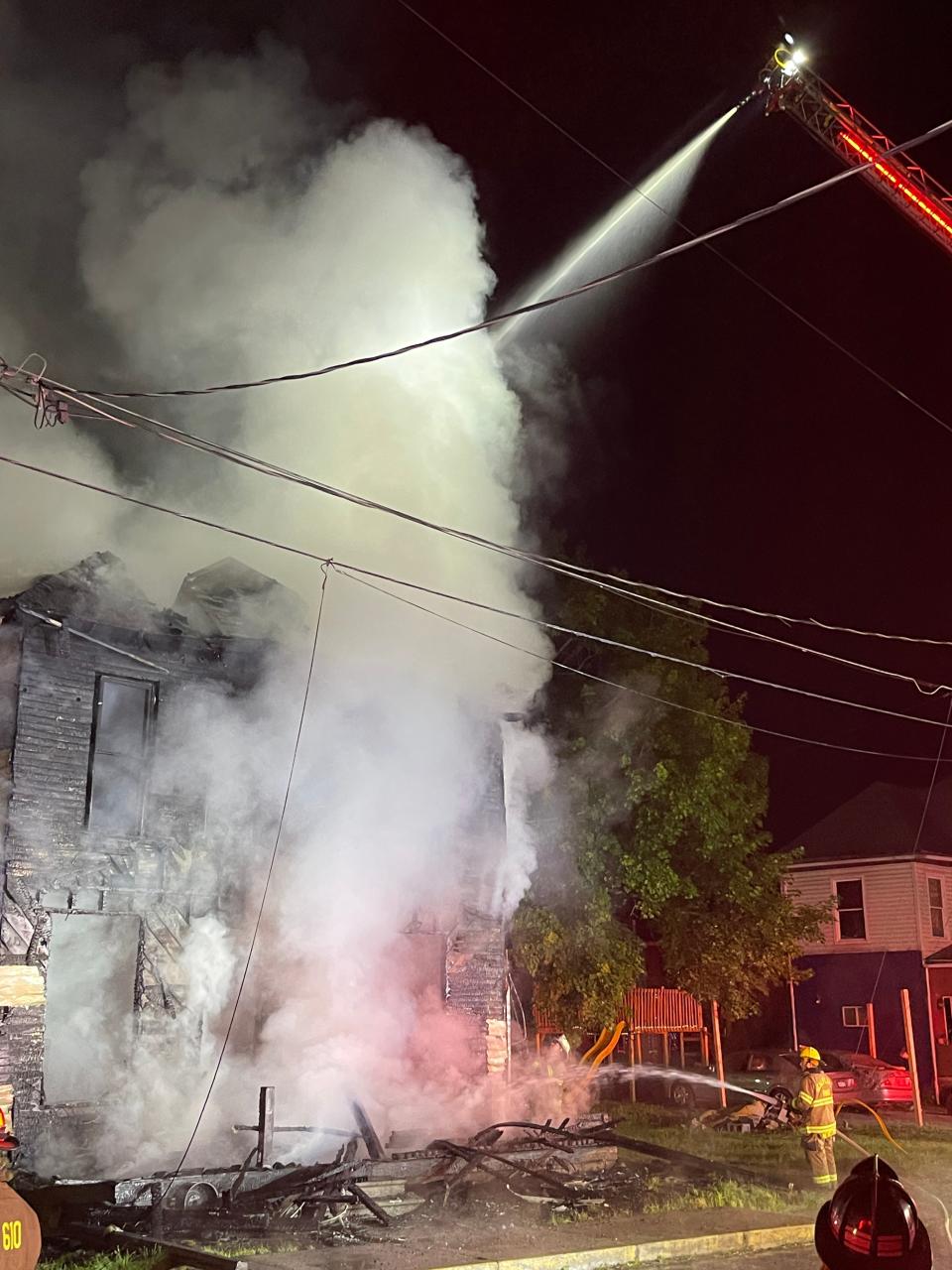 Smoke rises from the home as the West Hills aerial ladder truck sprays water onto the structure.