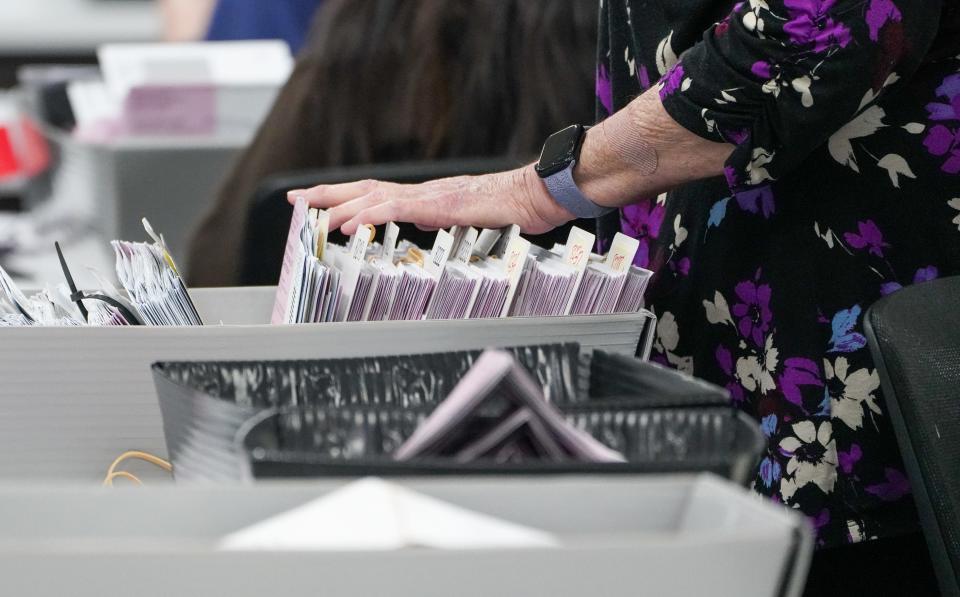 Election workers at the Washoe County Registrar of Voters office process ballots during February's presidential primary in Nevada. All 18 of the office's workers quit and had to be replaced between the 2020 election and the 2024 primary.