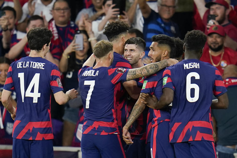 United States players celebrate with Christian Pulisic, center, after he scored a goal on a penalty kick, his second of the game, during the first half of a FIFA World Cup qualifying soccer match against Panama, Sunday, March 27, 2022, in Orlando, Fla. (AP Photo/Julio Cortez)