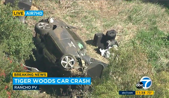 In this aerial image take from video provided by KABC-TV video, a vehicle rest on its side after a rollover accident involving golfer Tiger Woods along a road in the Rancho Palos Verdes section of Los Angeles on Tuesday, Feb. 23, 2021. Woods had to be extricated from the vehicle with the "jaws of life" tools, the Los Angeles County Sheriff's Department said in a statement. Woods was taken to the hospital with unspecified injuries. The vehicle sustained major damage, the sheriff's department said. (KABC-TV via AP)