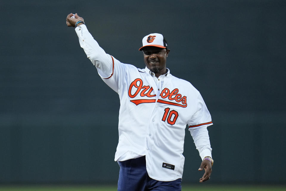 Former Baltimore Orioles player Adam Jones throws out a ceremonial pitch during a pregame ceremony as he officially retired from professional baseball prior to a game between the Orioles and the Tampa Bay Rays, Friday, Sept. 15, 2023, in Baltimore. (AP Photo/Julio Cortez)