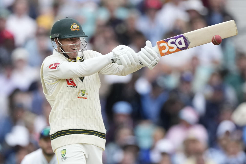 Australia's David Warner plays a shot off the bowling of England's Mark Wood on day four of the fifth Ashes Test match between England and Australia, at The Oval cricket ground in London, Sunday, July 30, 2023. (AP Photo/Kirsty Wigglesworth)