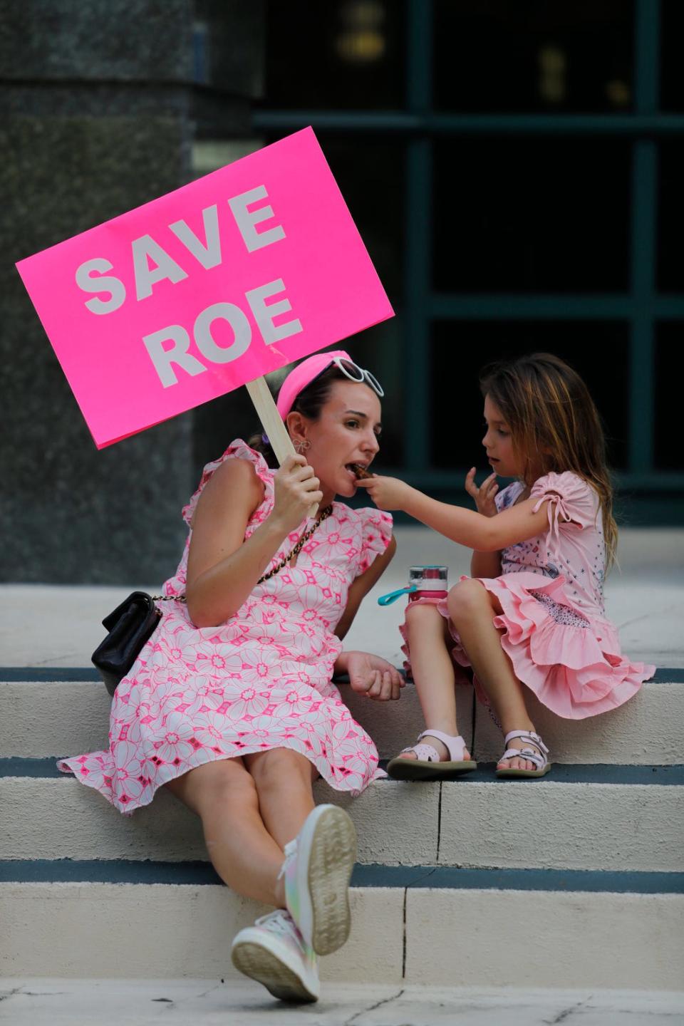 Naples resident Jennifer Gostin sits with her daughter Aviva, 5, prior to a pro choice rally Tuesday, May 3, 2022. About 75 pro choice supporters gathered in front of the Collier County Courthouse and marched to the intersection of US 41 and Airport-Pulling Rd. S. to rally in response to the leaked Roe vs. Wade Supreme Court opinion.