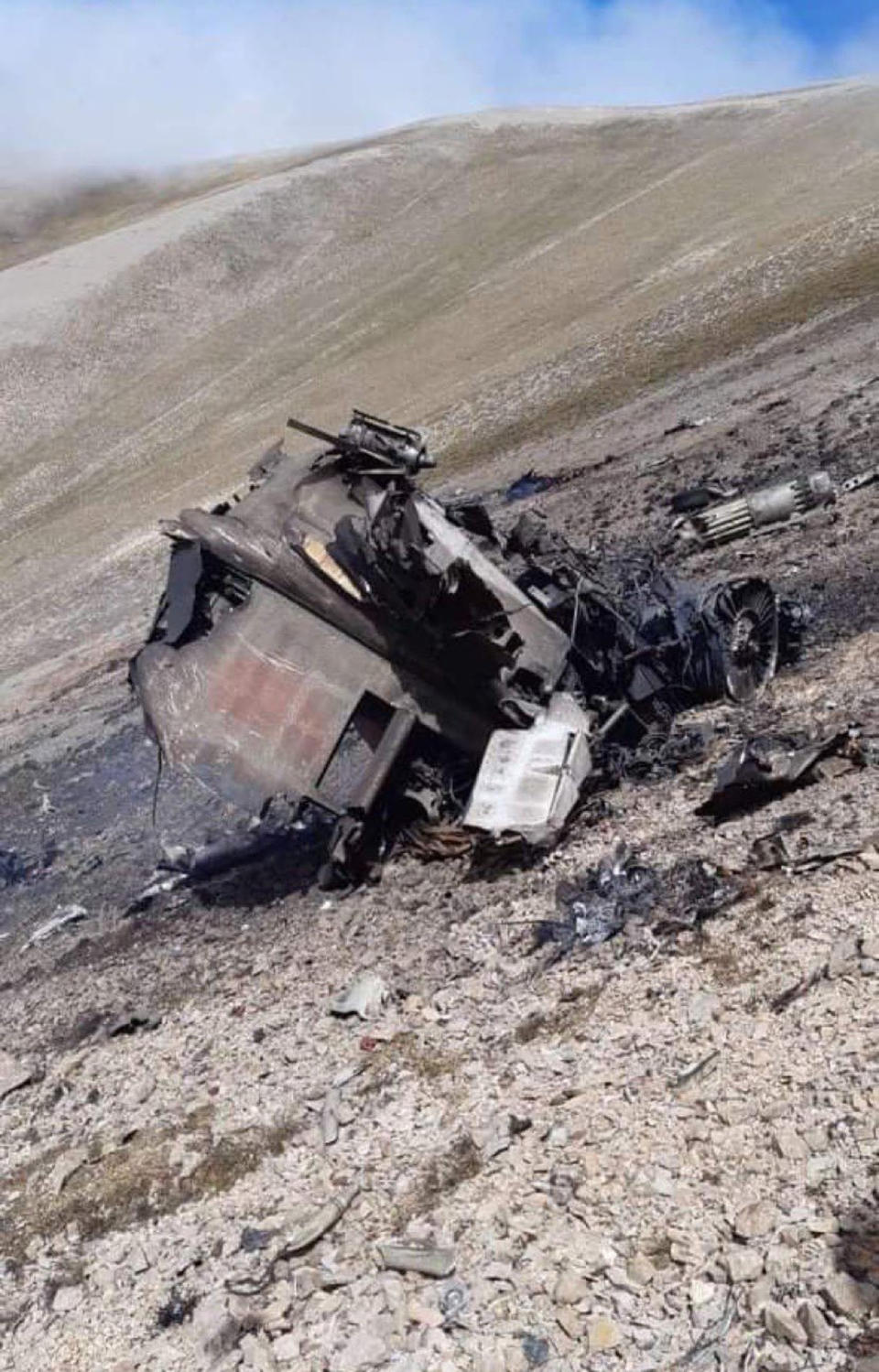 This photo released by Armenian Foreign Ministry on Wednesday, Sept. 30, 2020, shows the wreckage of an Armenian air forces warplane on a hill in the self-proclaimed Republic of Nagorno-Karabakh near the town of Vardenis, Armenia. The conflict escalated on Tuesday, with Armenia alleging Turkish involvement and claiming that a Turkish F-16 fighter jet shot down an SU-25 from its air force in Armenian airspace, killing the pilot. Turkey, which has been vocal about siding with Azerbaijan in the dispute, denied those claims, and so did Azerbaijan. (Armenian Foreign Ministry via AP)