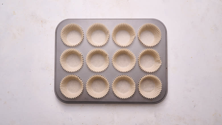 muffin tin filled with cupcake liners