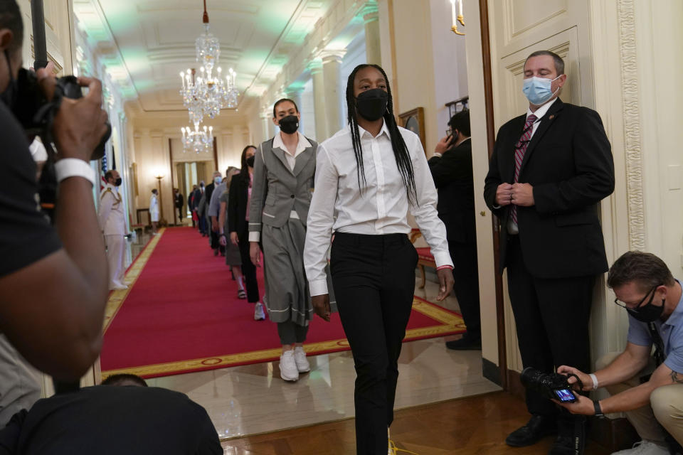 Seattle Storm's Jewell Loyd, center, followed by Breanna Stewart, walk into the East Room of the White House in Washington, Monday, Aug. 23, 2021, for an event with President Joe Biden to celebrate their 2020 WNBA Championship. (AP Photo/Susan Walsh)