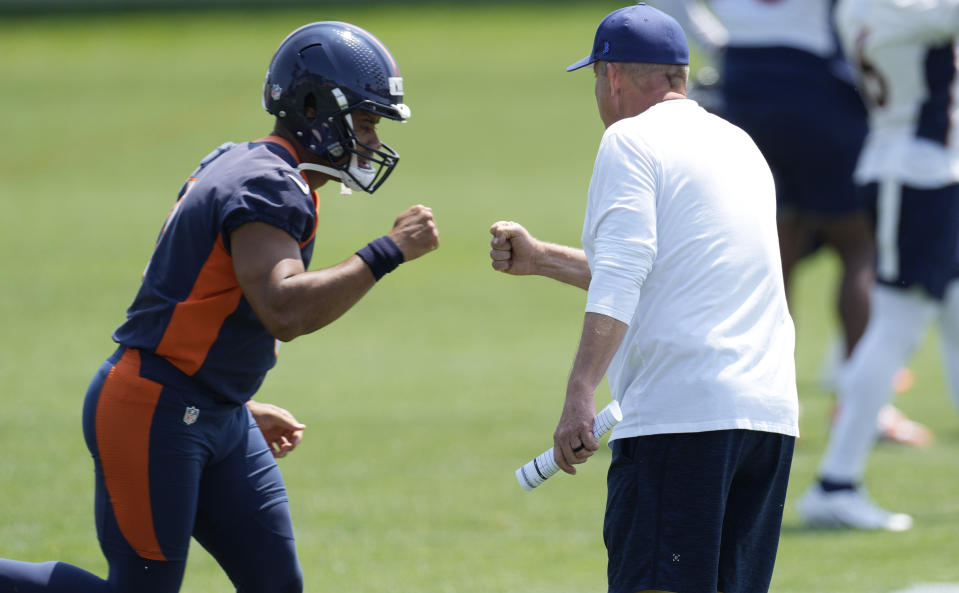 Denver Broncos quarterback Russell Wilson, left, bumps fists with head coach Sean Payton during NFL football practice, Wednesday, June 14, 2023, in Centennial, Colo. (AP Photo/David Zalubowski)