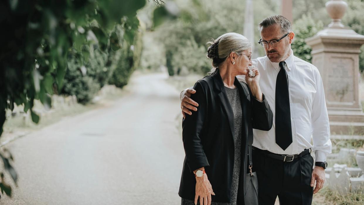 Husband trying to comfort his wife due to her loss.