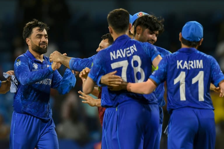 Afghanistan captain Rashid Khan (L) celebrates with his teammates after the 'massive' win over Australia at the T20 World Cup (Randy Brooks)